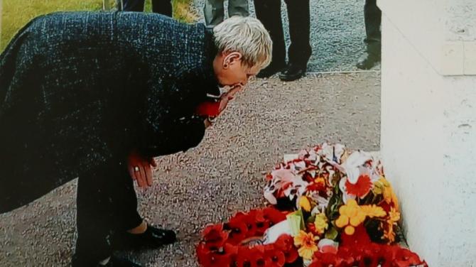 Lily lays a wreath in her father’s memory